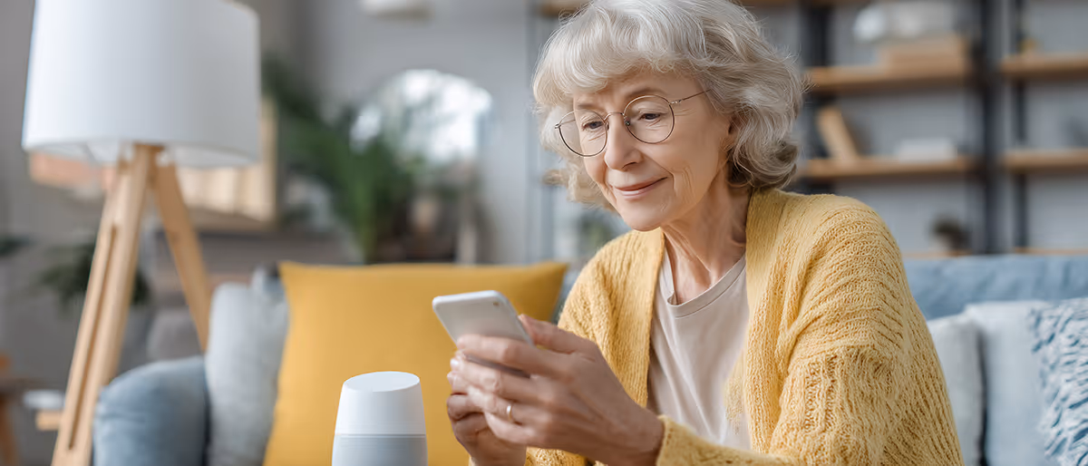 Homeowner reviewing safety notes on a phone while seated in a living room